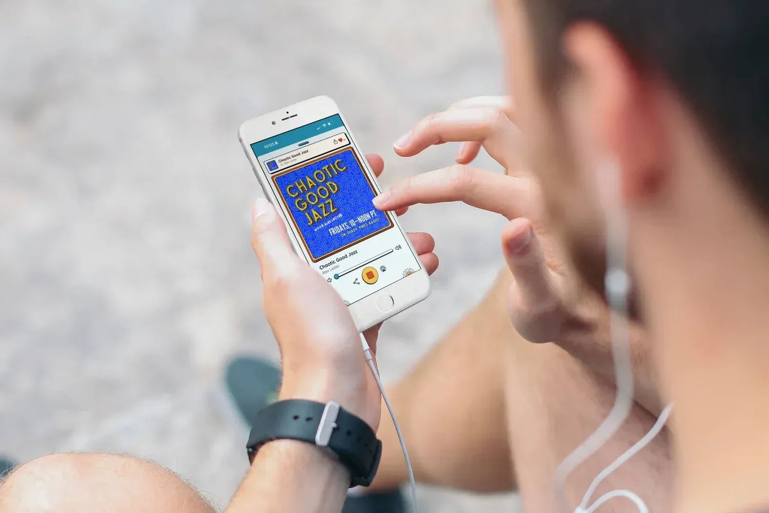 Hand holding a phone displaying an Instagram profile for a real estate business.