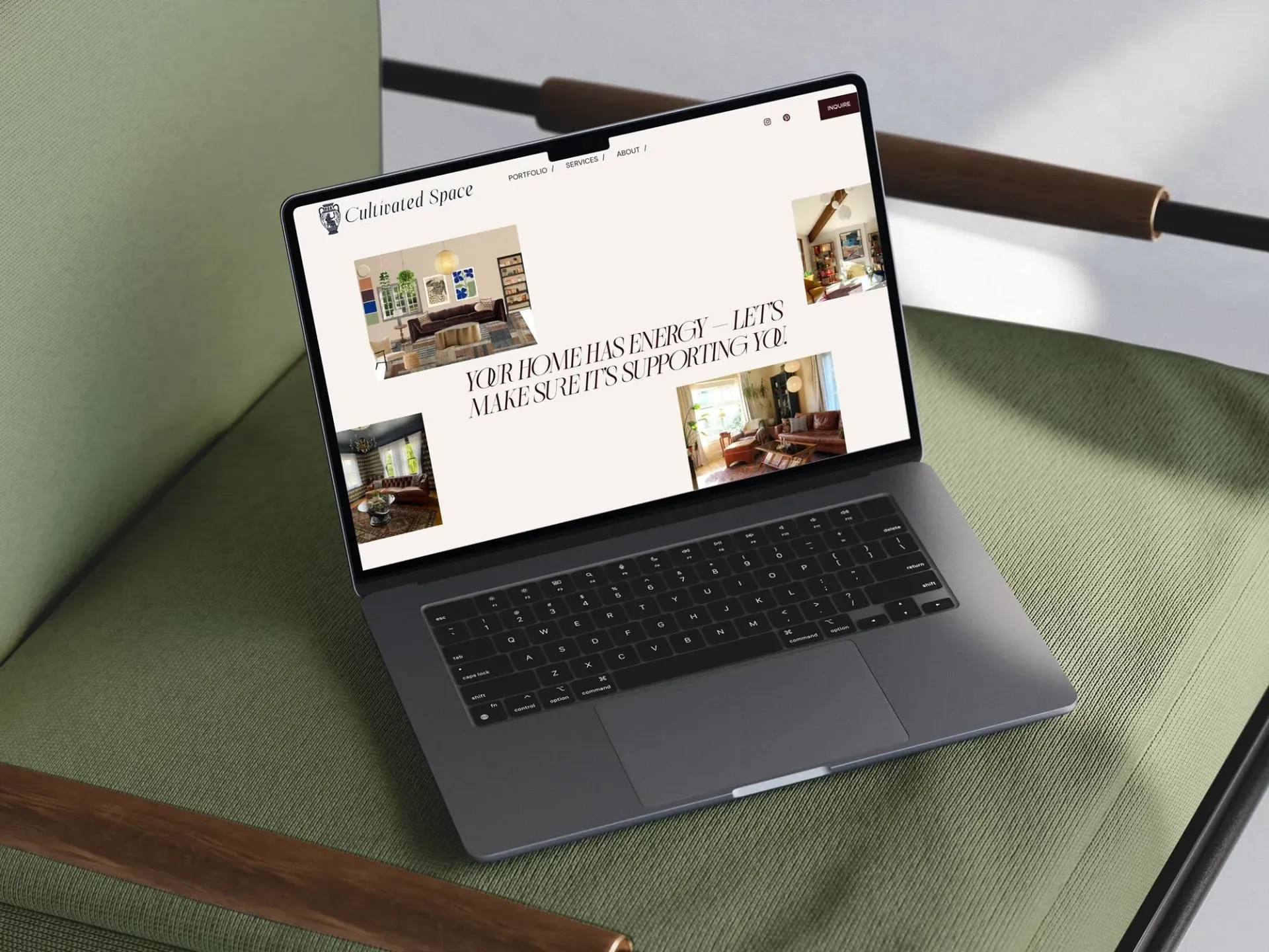 Laptop displaying a website with interior design images, sitting on a green chair.
