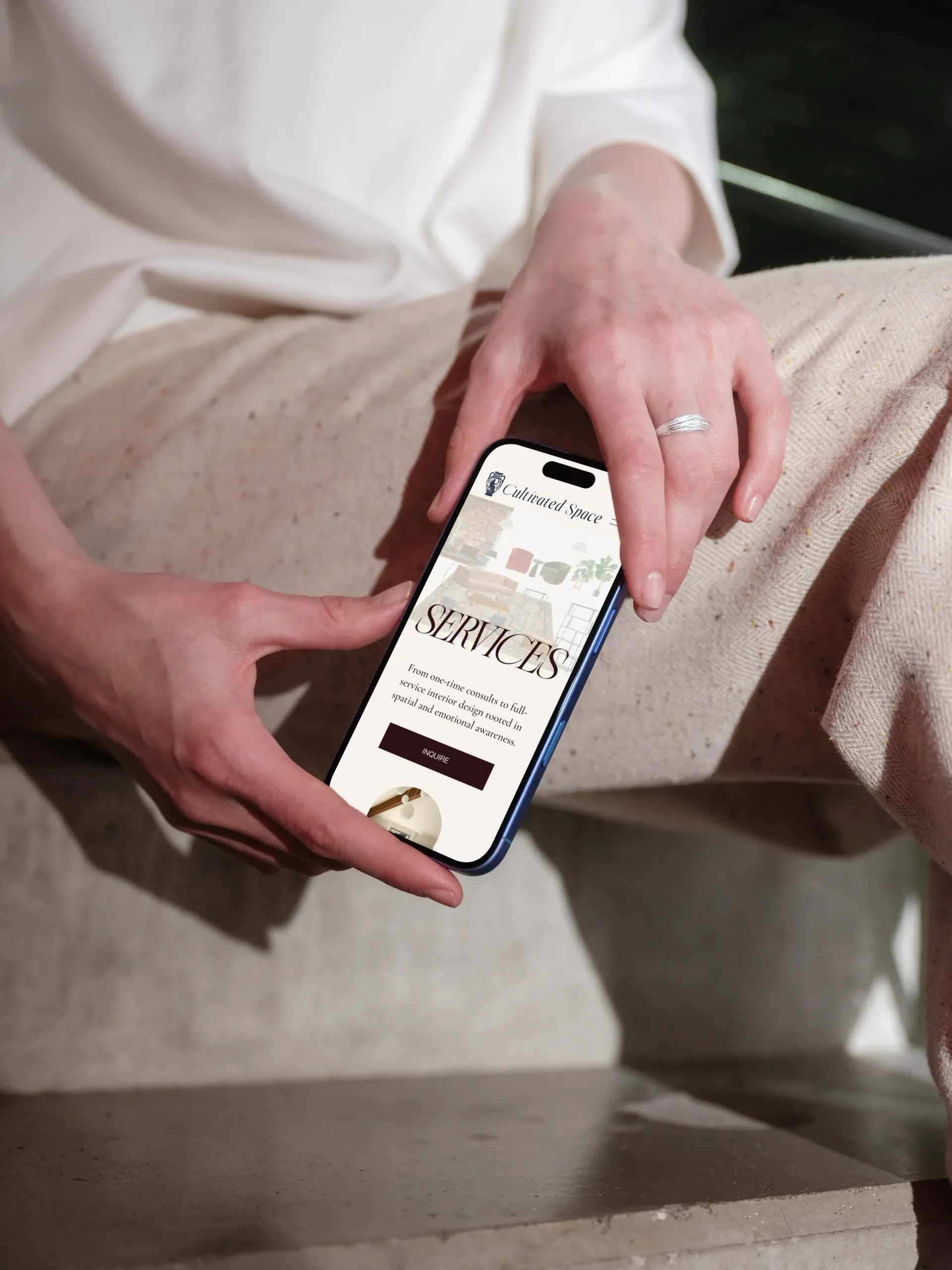 Person holding a phone displaying a website