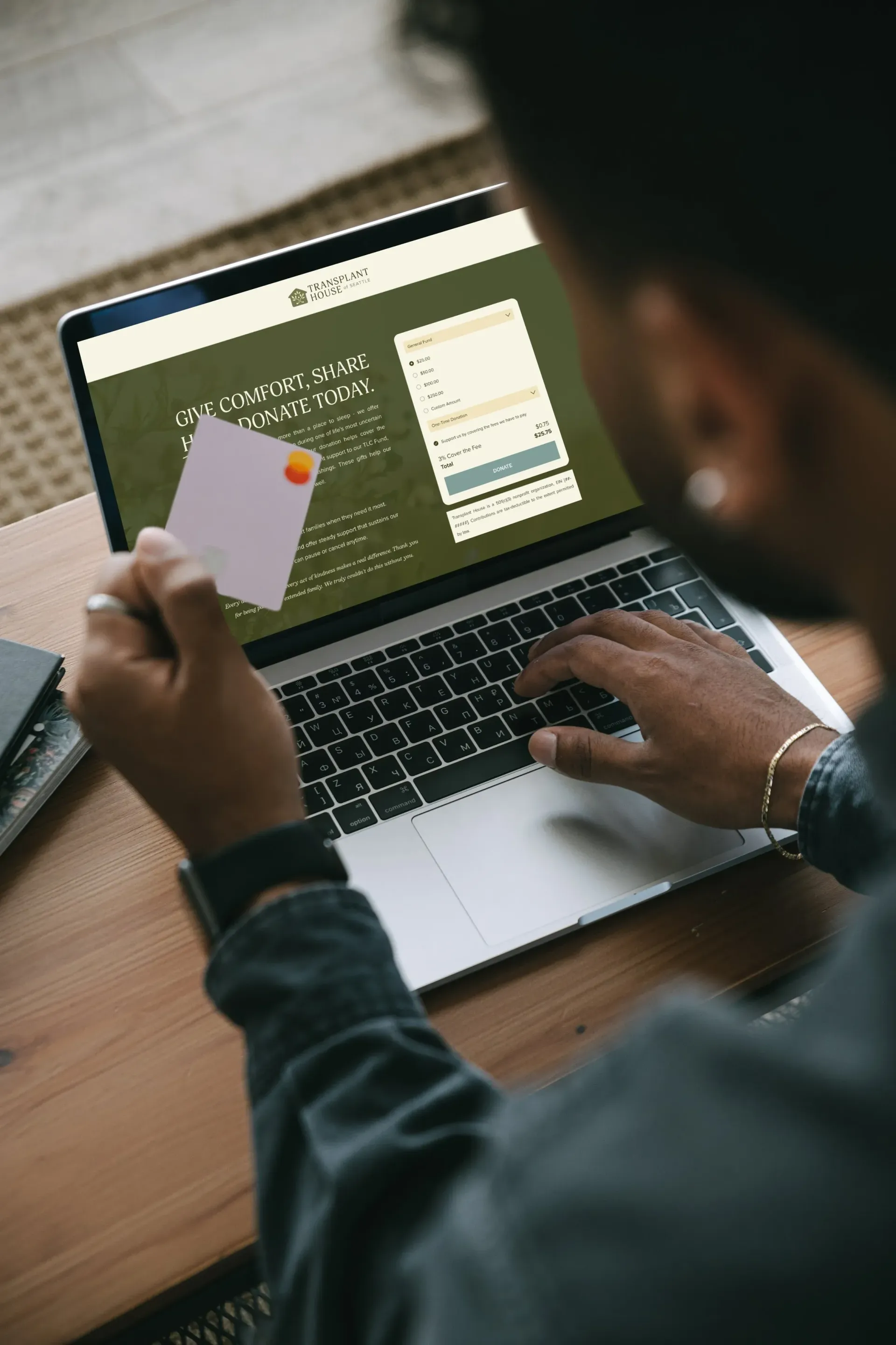 Person using laptop, holding credit card to fill online form.