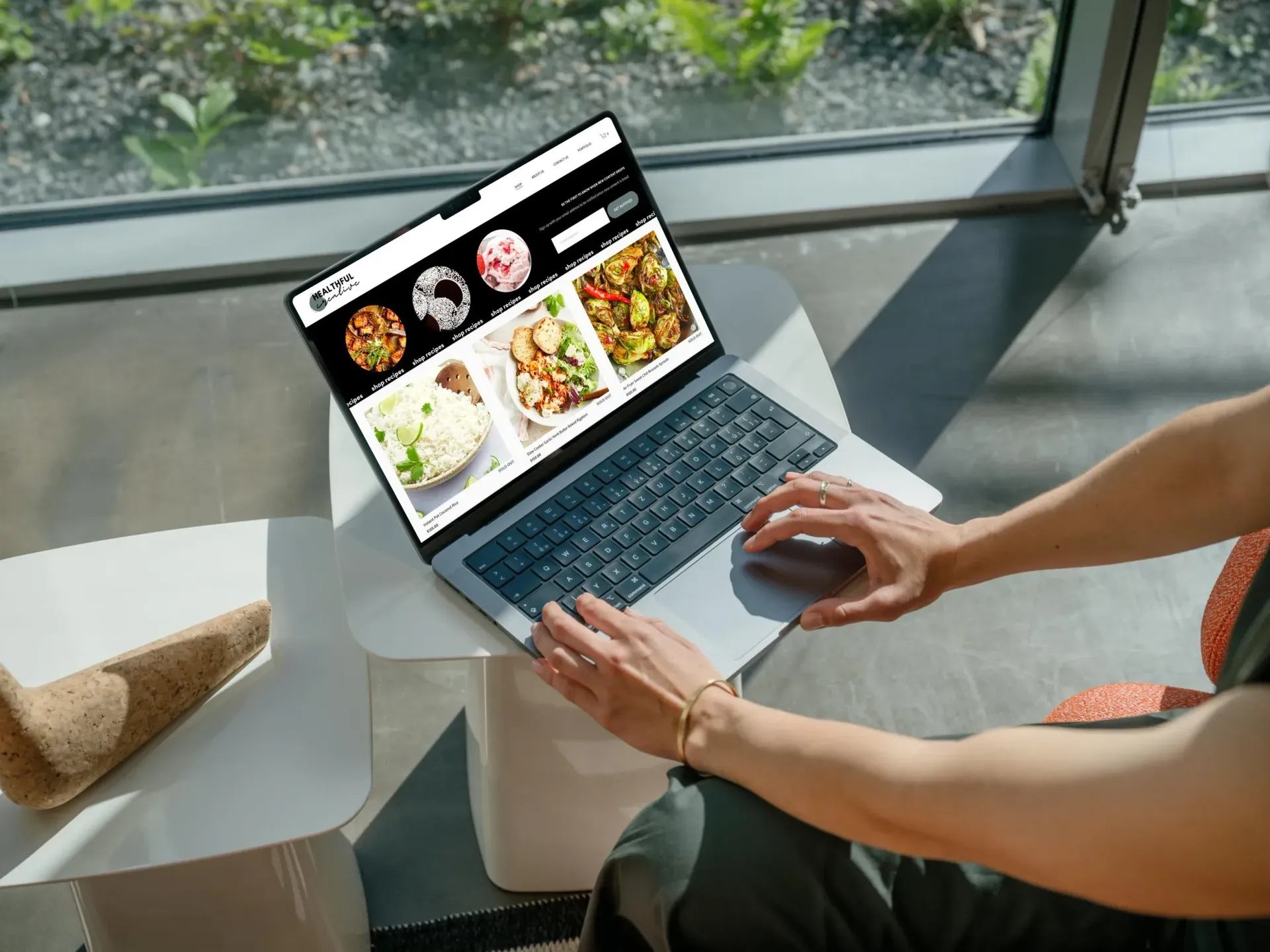 Hand holding a phone displaying an Instagram profile for a real estate business.