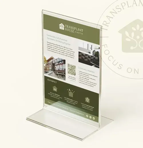An informational flyer in a clear acrylic stand. Features the logo for Transplant House.