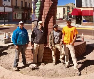 Masonry Consulting — Four Men Standing in Front of Tower Masonry in Pueblo, CO