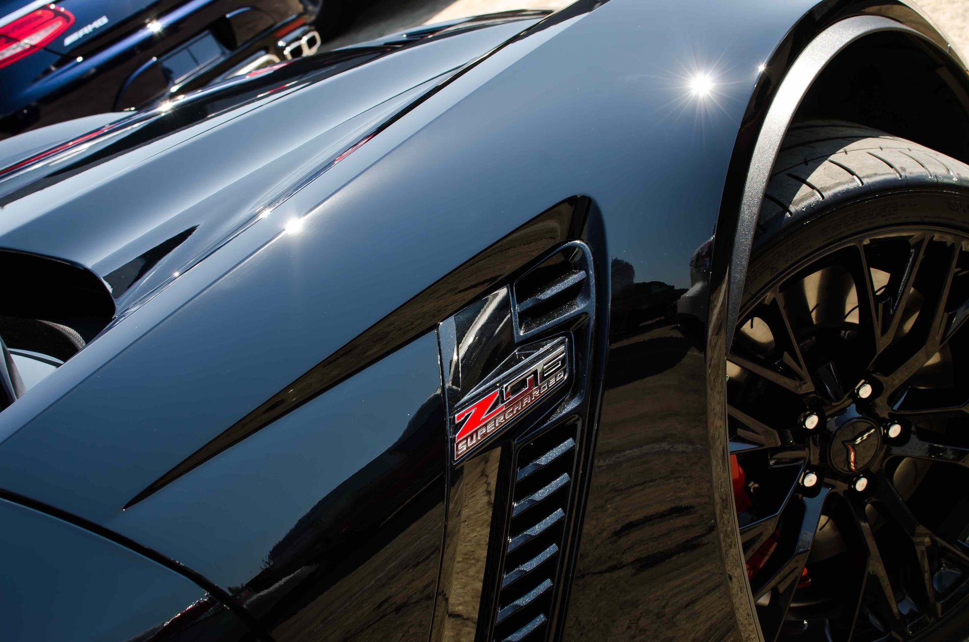 A blue subaru with the hood open and the engine exposed.