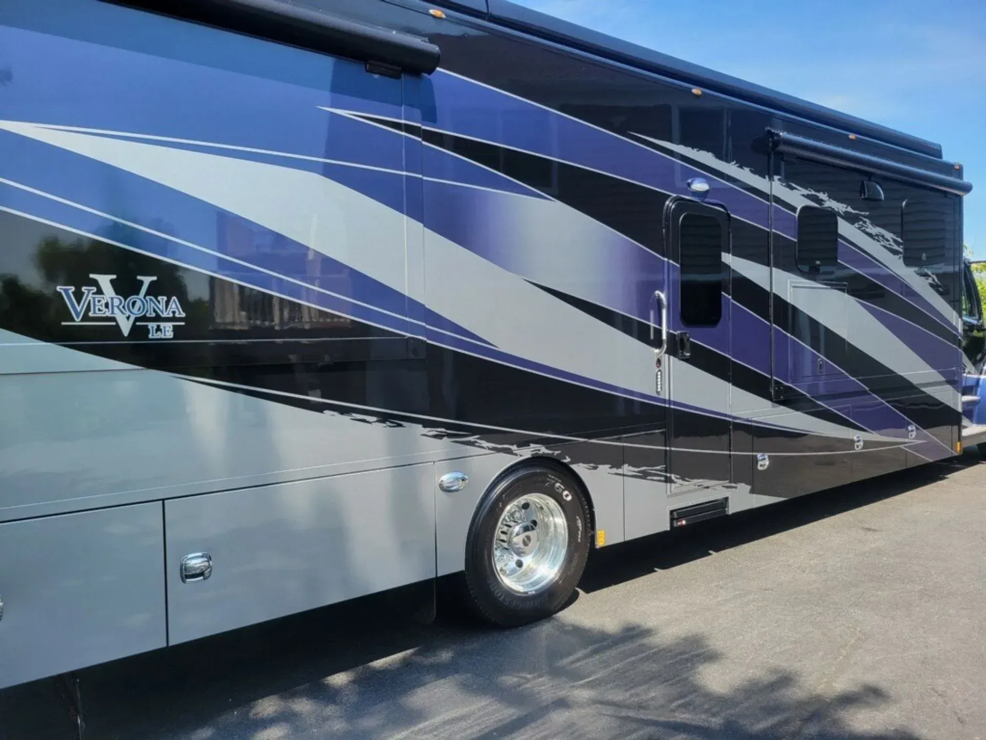 A large rv is parked on the side of the road.
