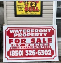 A sign that says waterfront property for sale by owner finance with terms