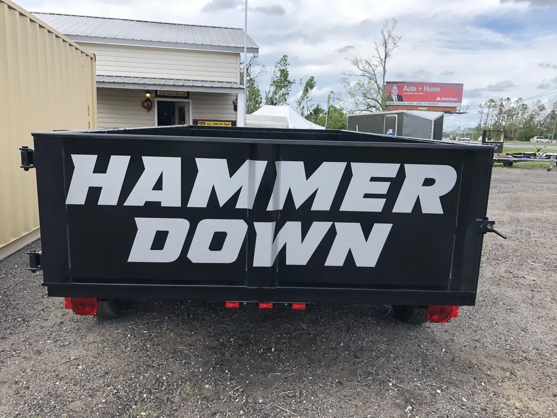 A dumpster with the words hammer down on it