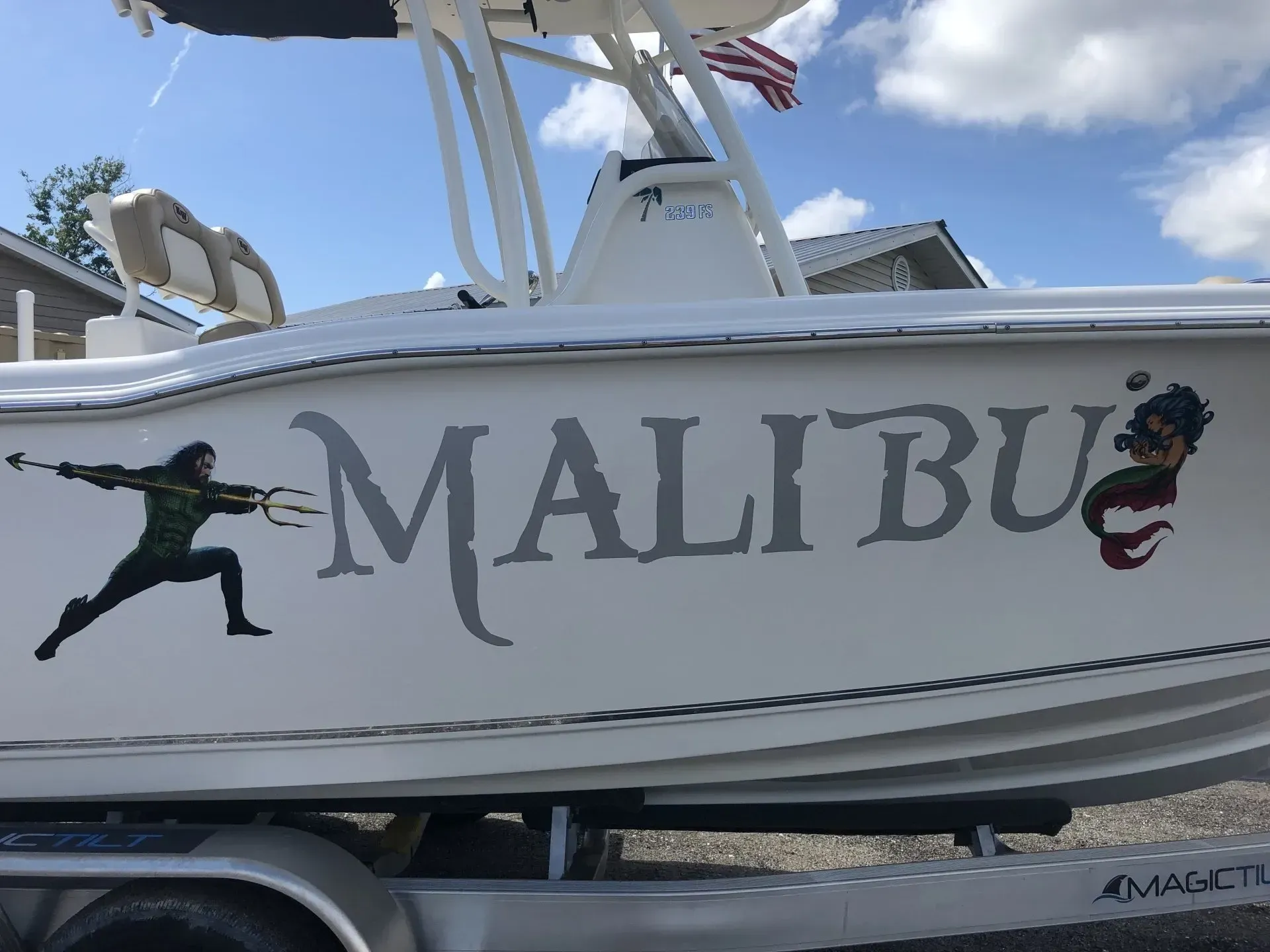 A white boat with the word malibu painted on it