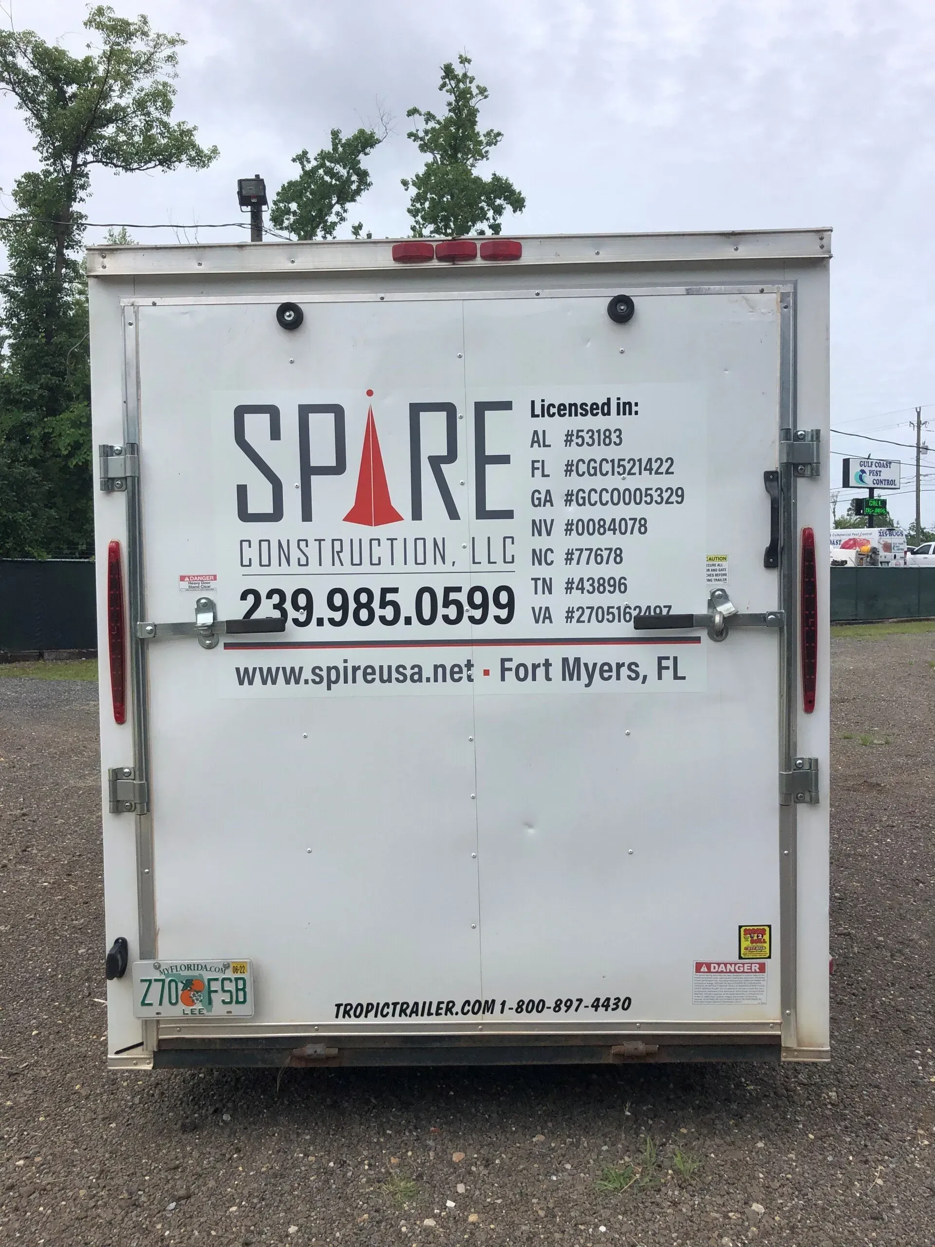 A white trailer with spare construction llc written on it
