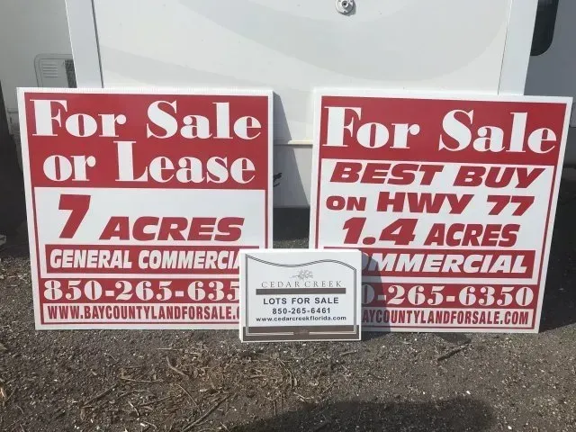 A couple of signs that say for sale or lease