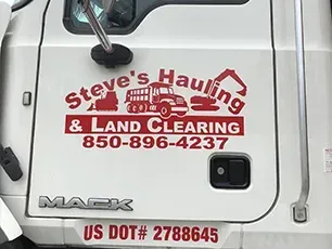 A white truck with steve 's hauling and land clearing written on it