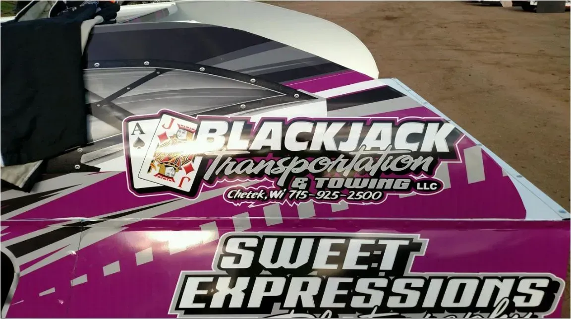 A race car with BlackJack Transportation logo on it.