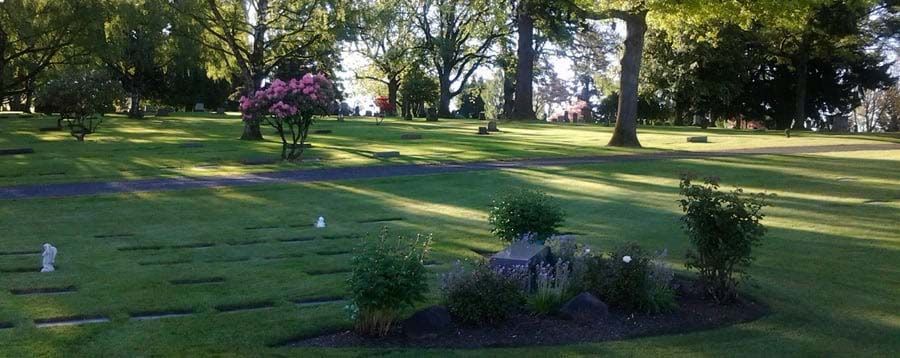 A cemetery with a lot of grass and trees