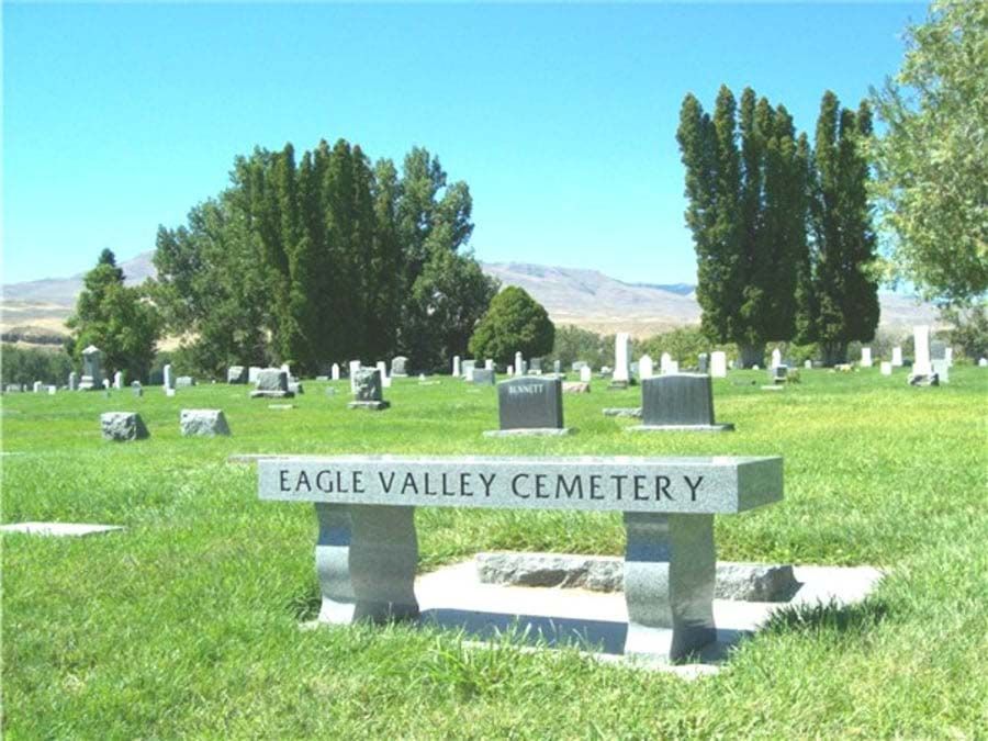 Eagle valley cemetery with a bench in the foreground