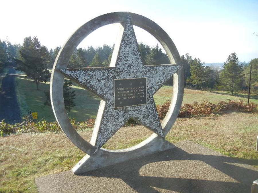 A large star in a circle with a plaque on it