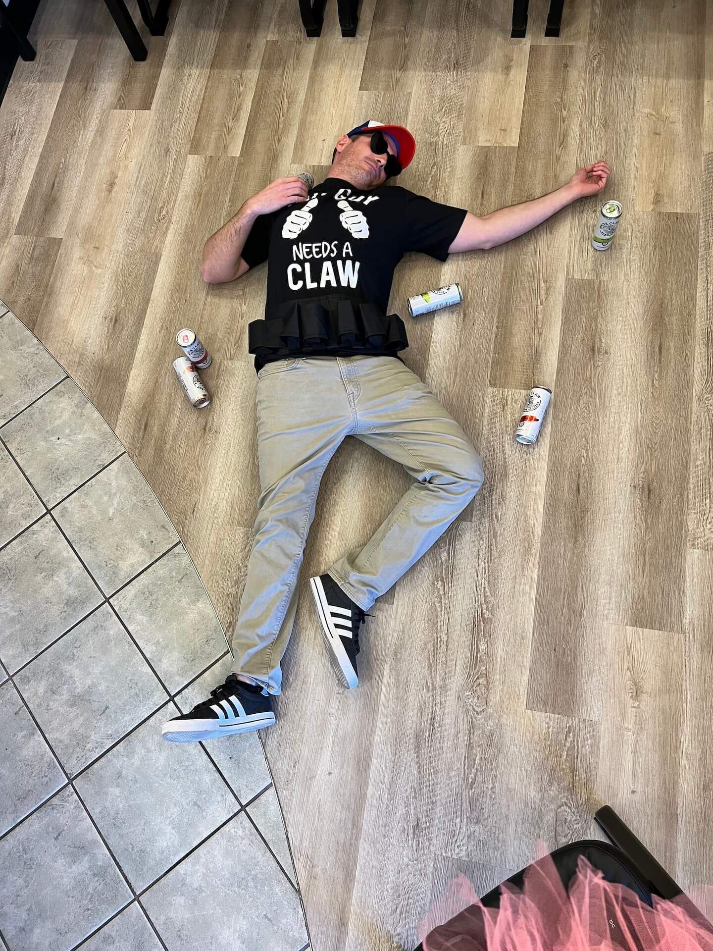 A man is laying on the floor with his arms outstretched.