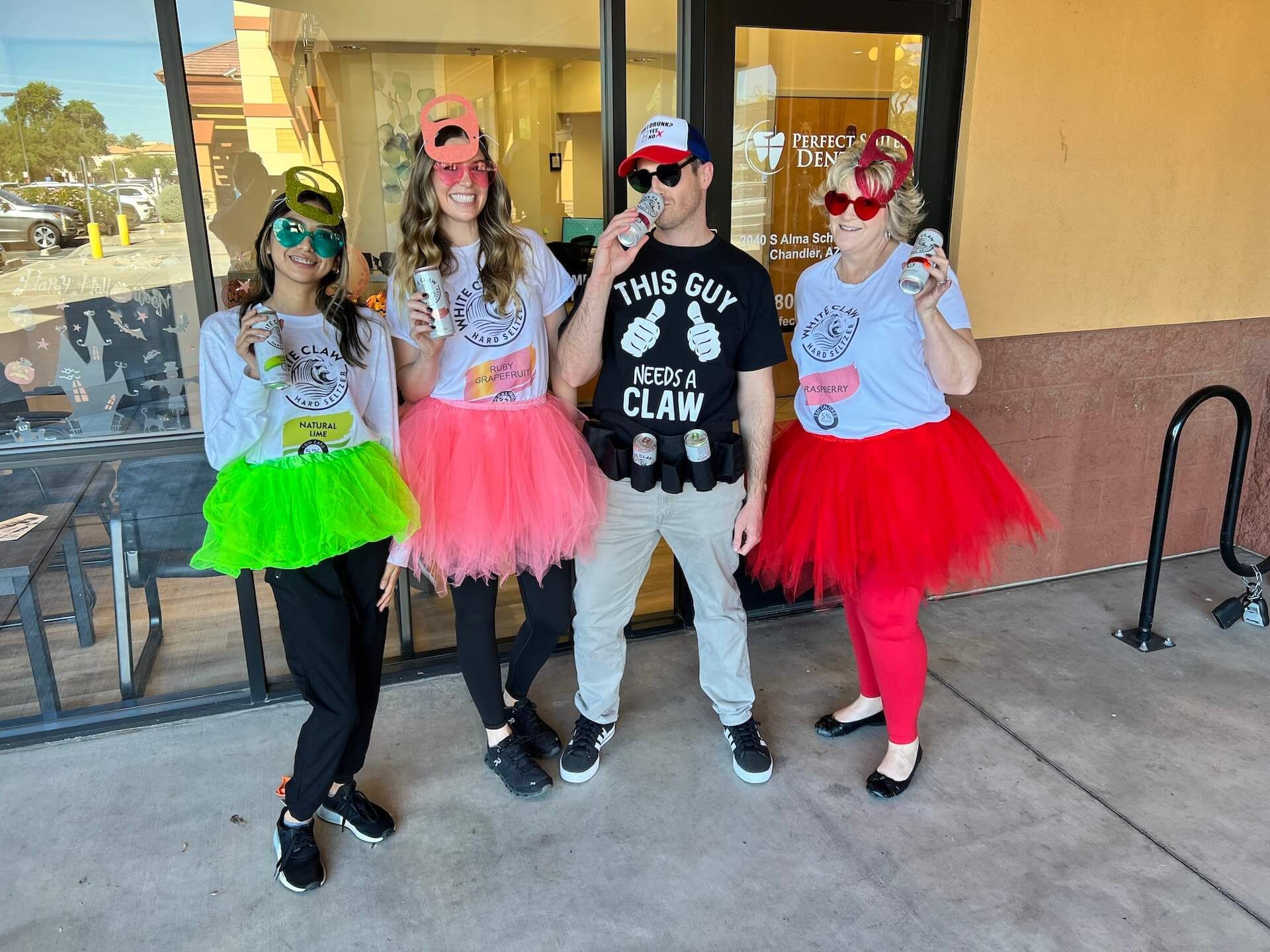 A group of people are posing for a picture in front of a store.