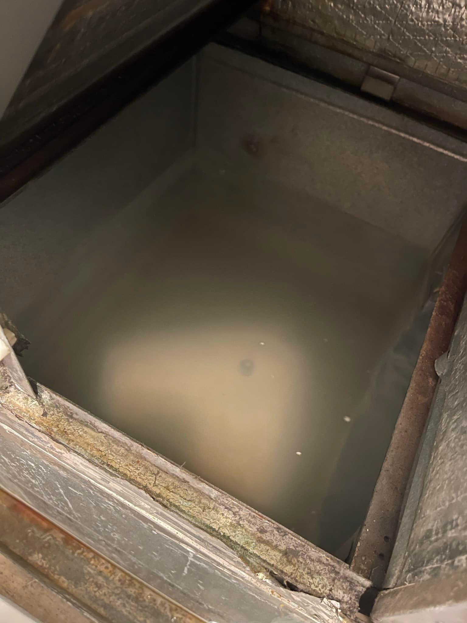 A close up of a metal container filled with water.