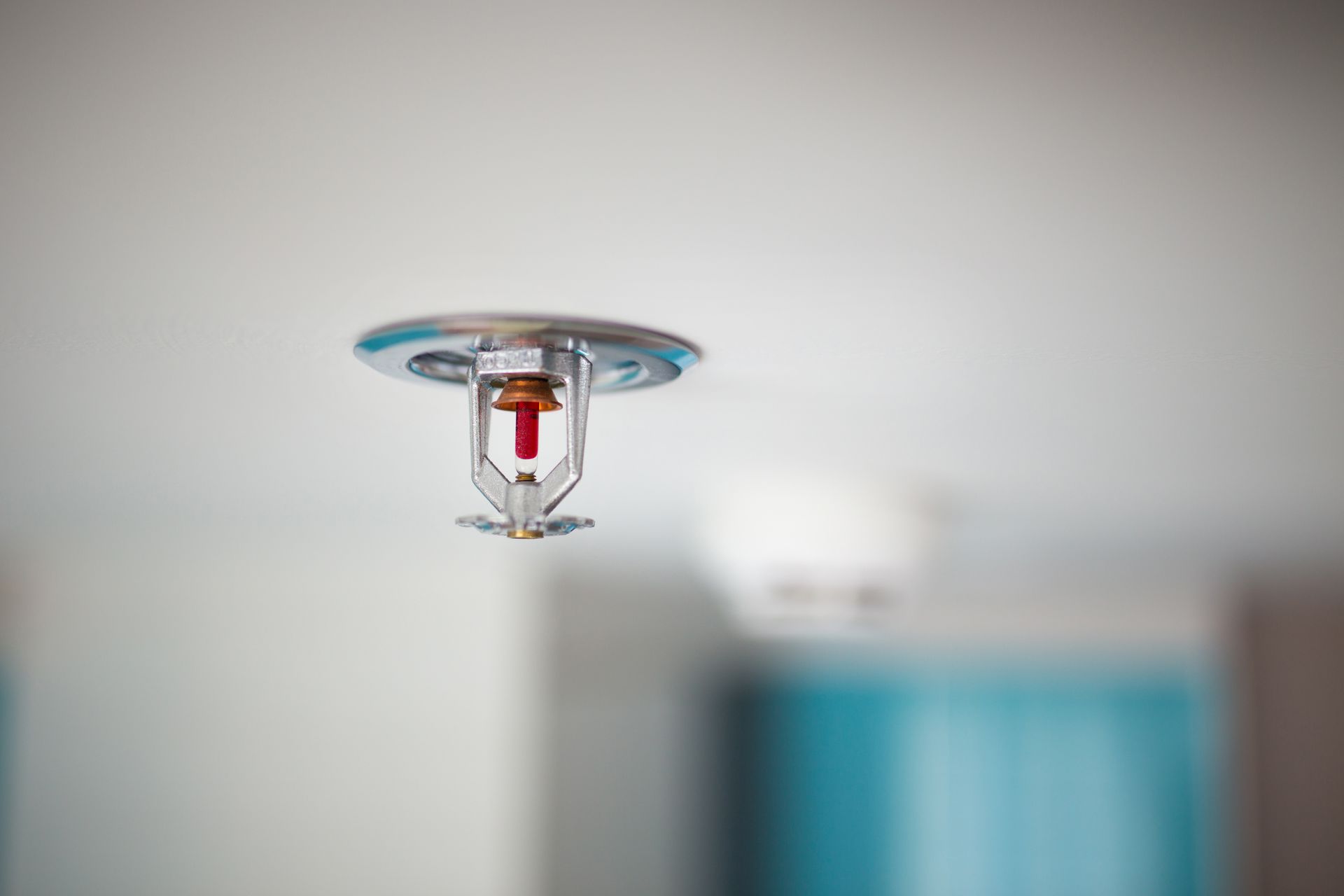 A fire sprinkler on a ceiling