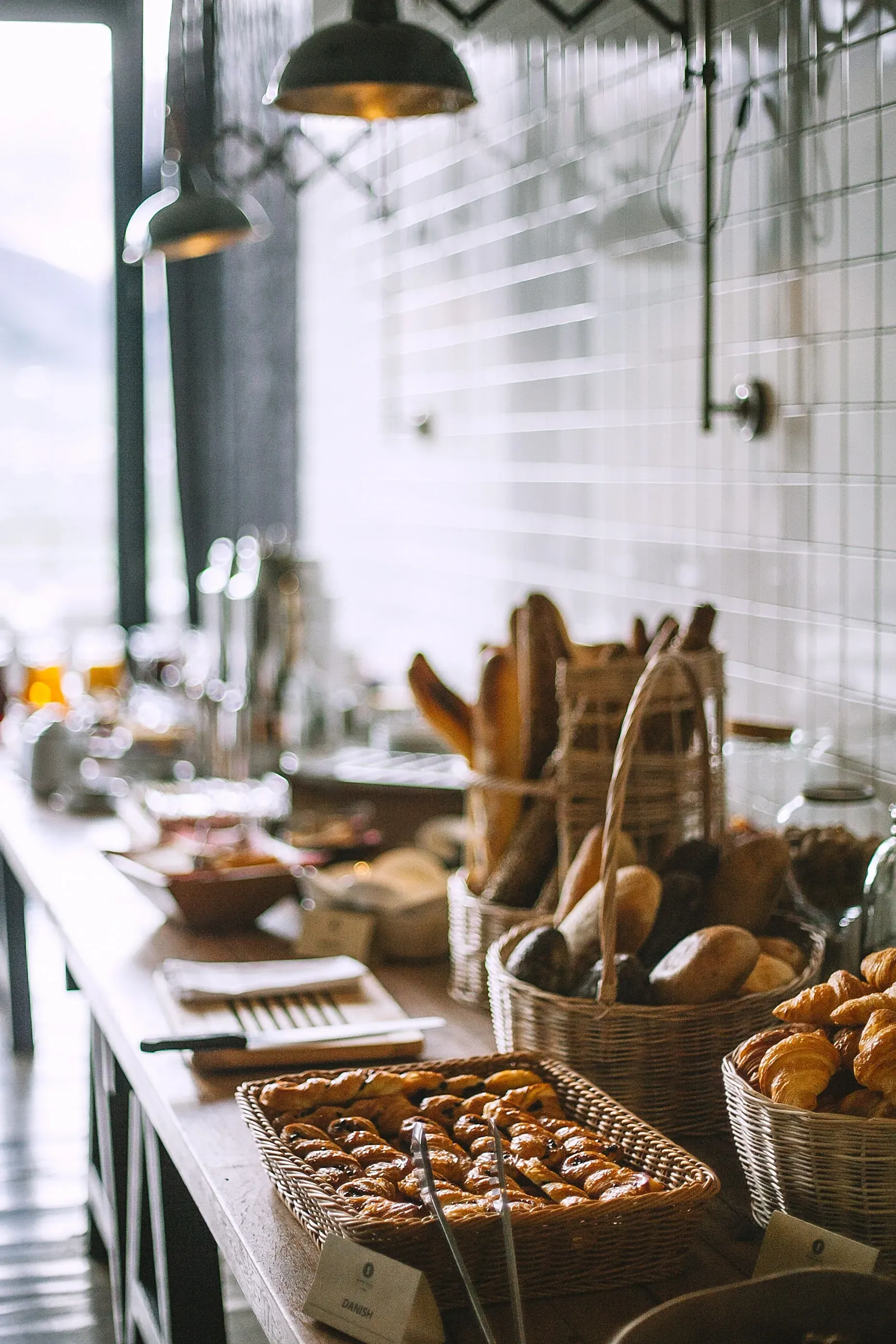 Breakfast buffet with pastries and bread.