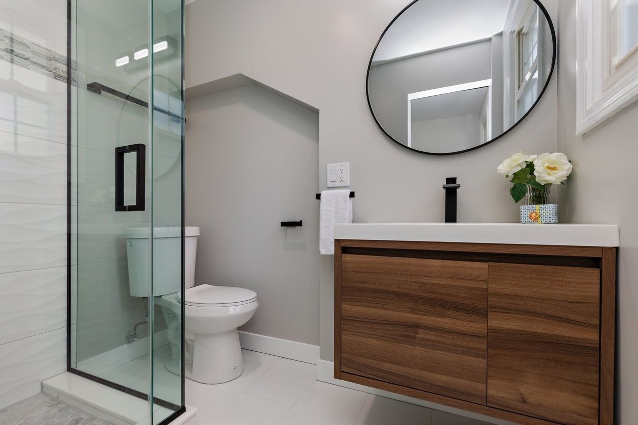 A bathroom with a toilet , sink , and shower.