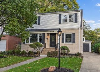 The front of a house with a lamp post in front of it.