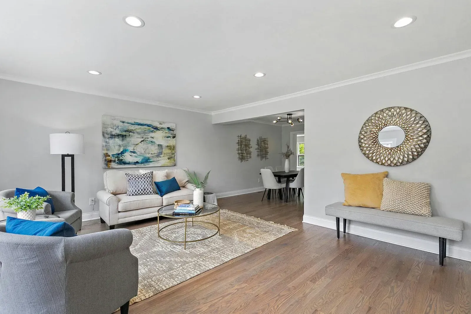 A living room with a couch , chairs , and a bench.