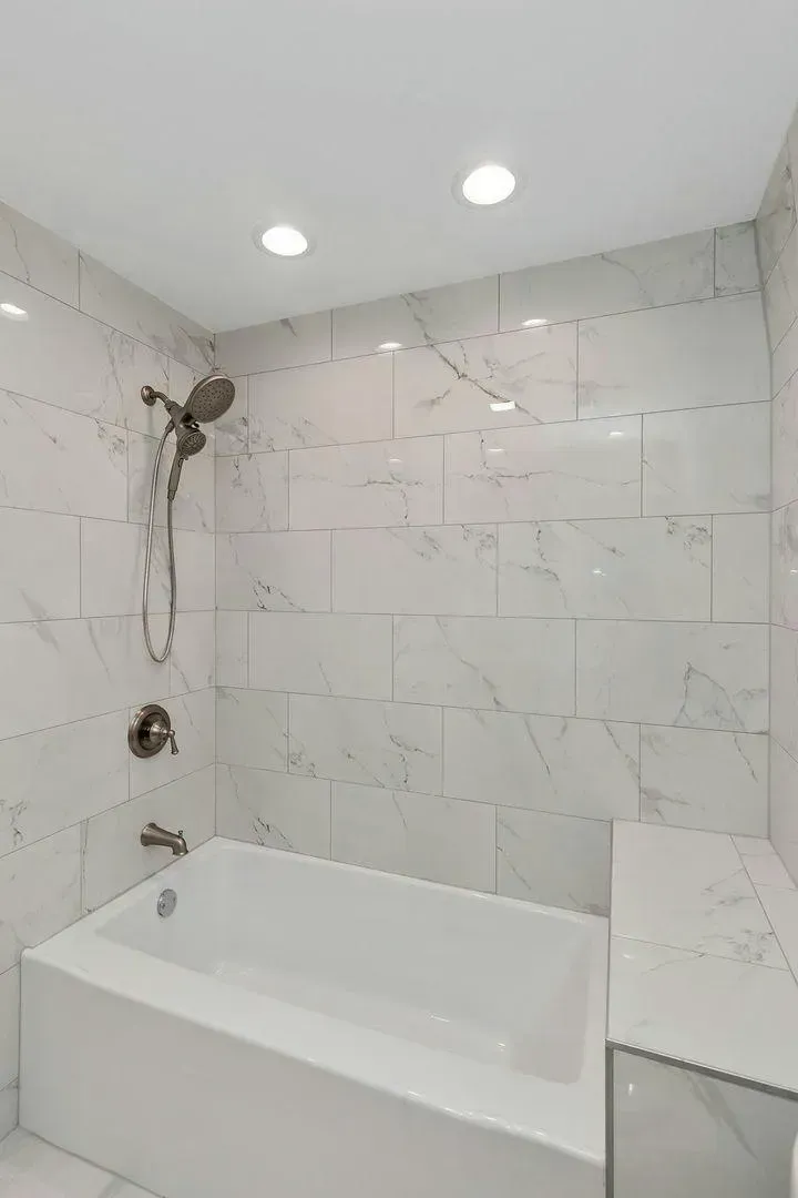 A bathroom with a bathtub and a shower.