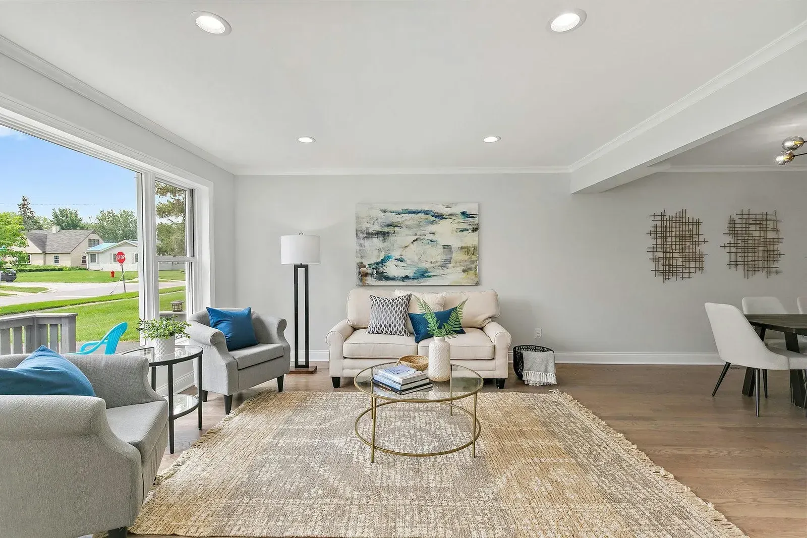 A living room with a couch , chairs , and a rug.