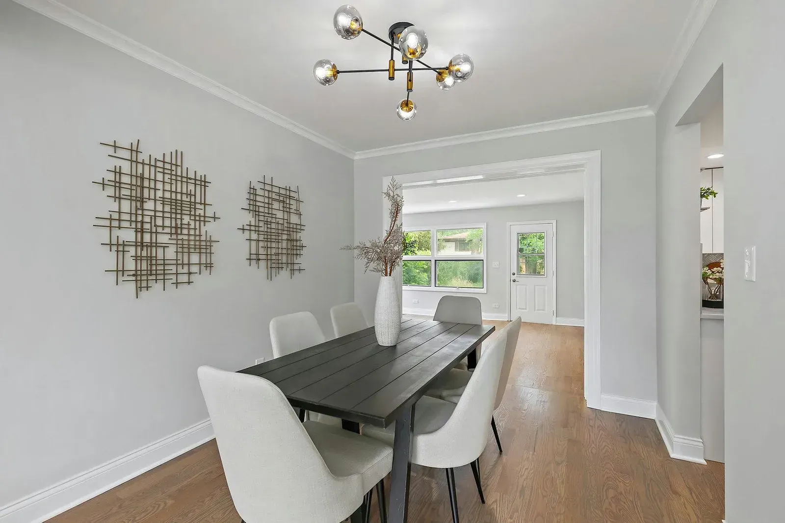 A dining room with a table and chairs and a chandelier.
