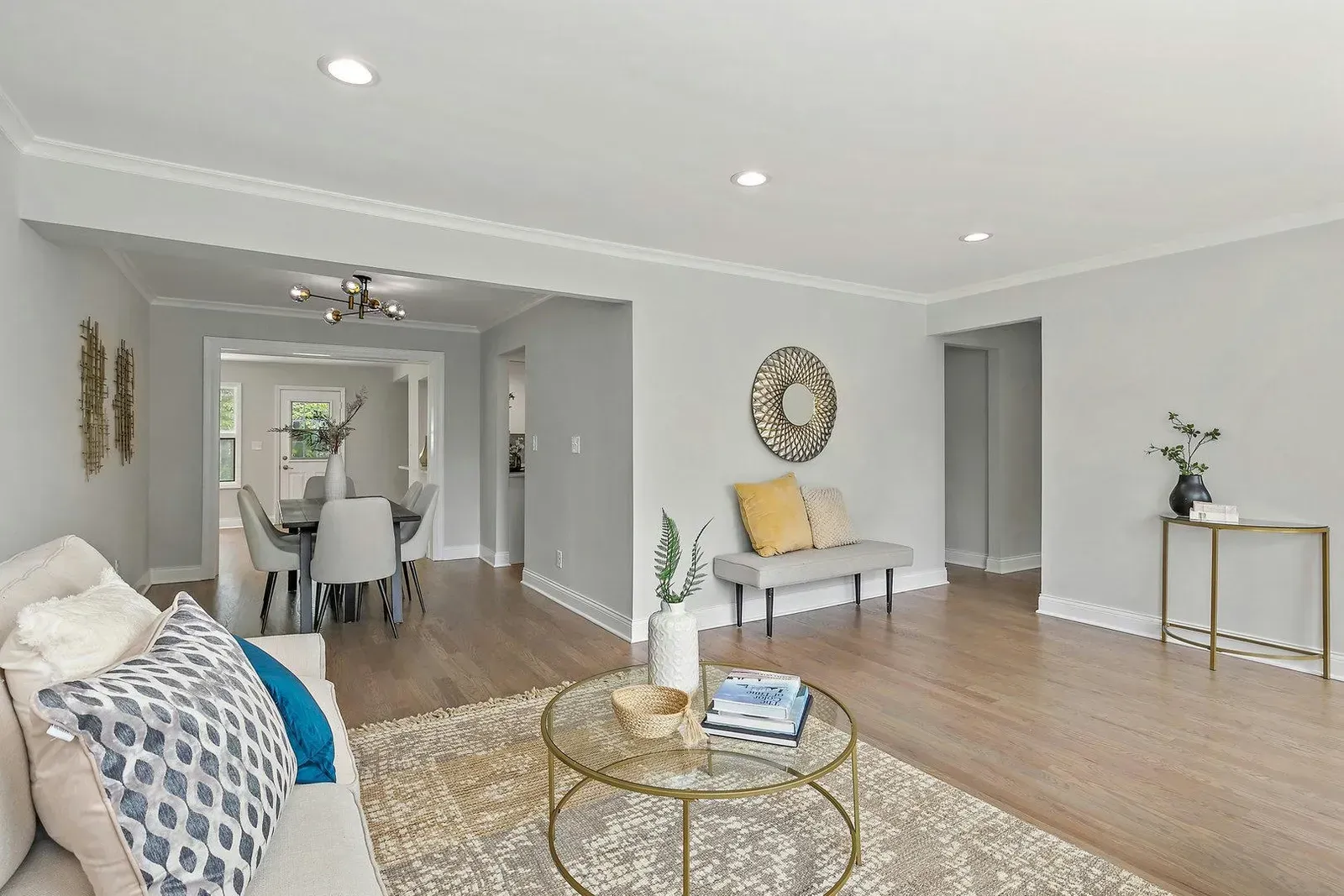 A living room with a couch , table , chairs and a rug.