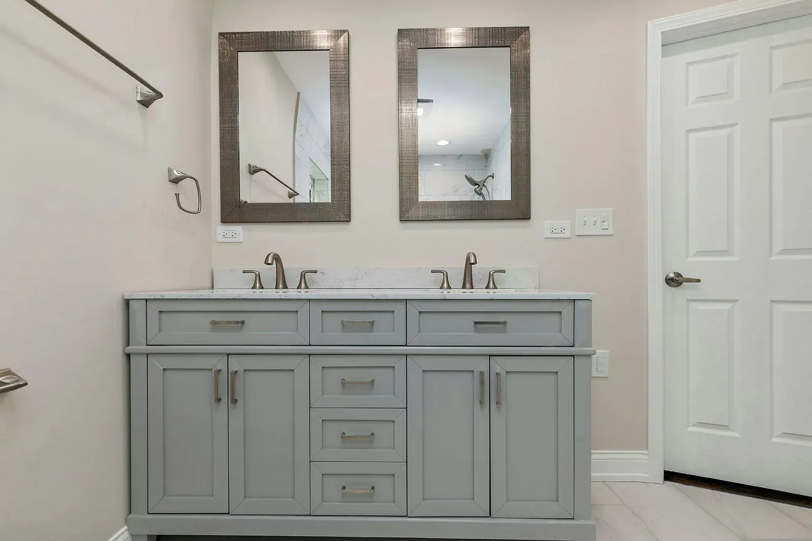 A bathroom with two sinks and two mirrors.
