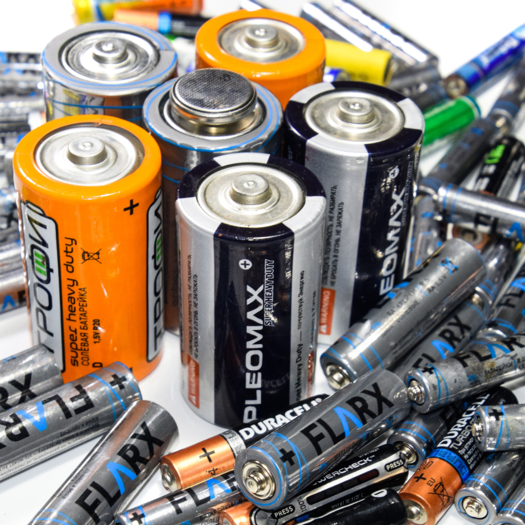 A pile of different types of batteries including pleomax