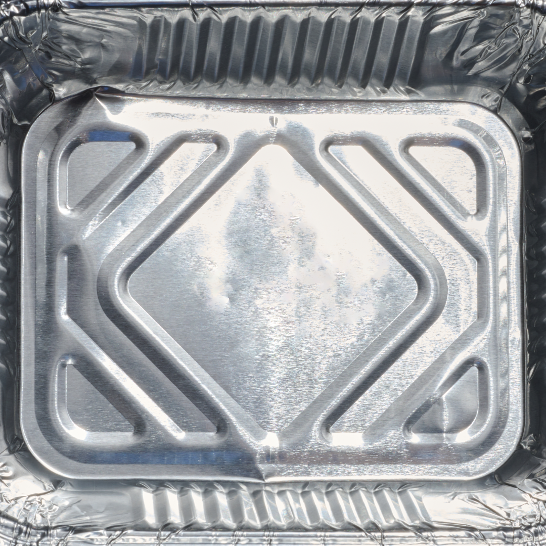 A silver aluminum foil container with a clear lid
