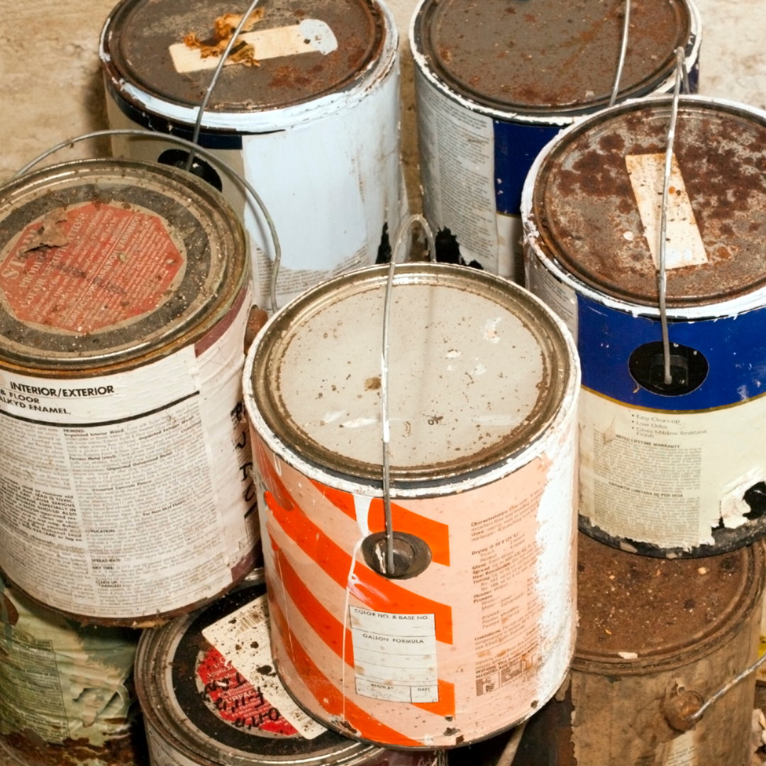 Several cans of paint are stacked on top of each other