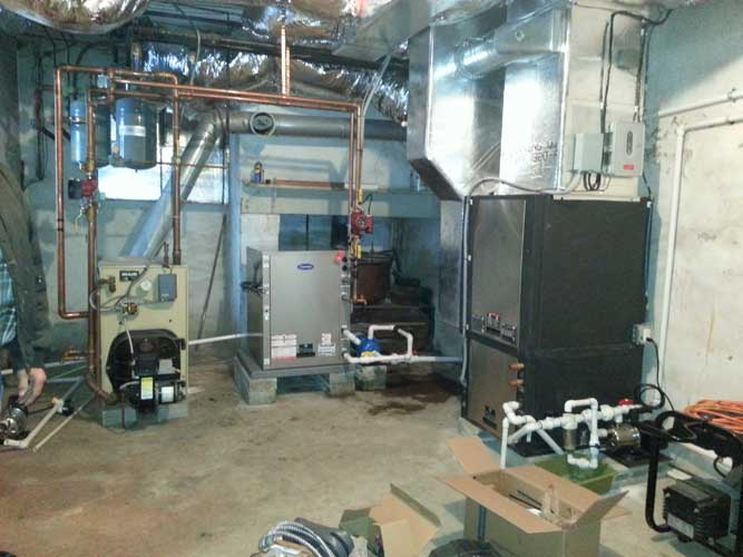 A room with a lot of pipes and a box on the floor