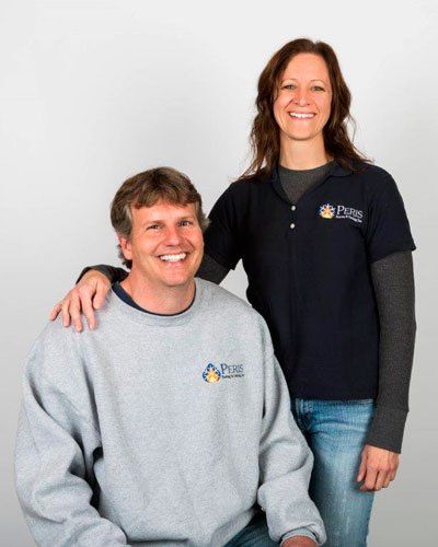 A man and a woman are standing next to each other and smiling.