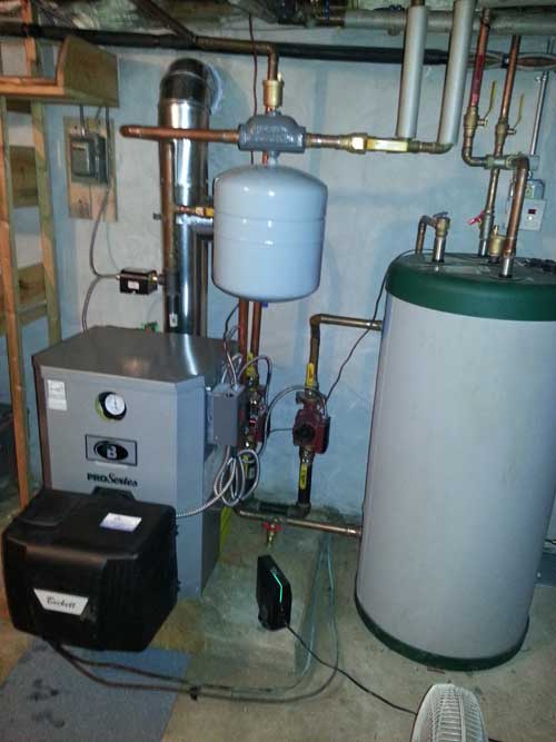 A boiler and a water heater are in a basement