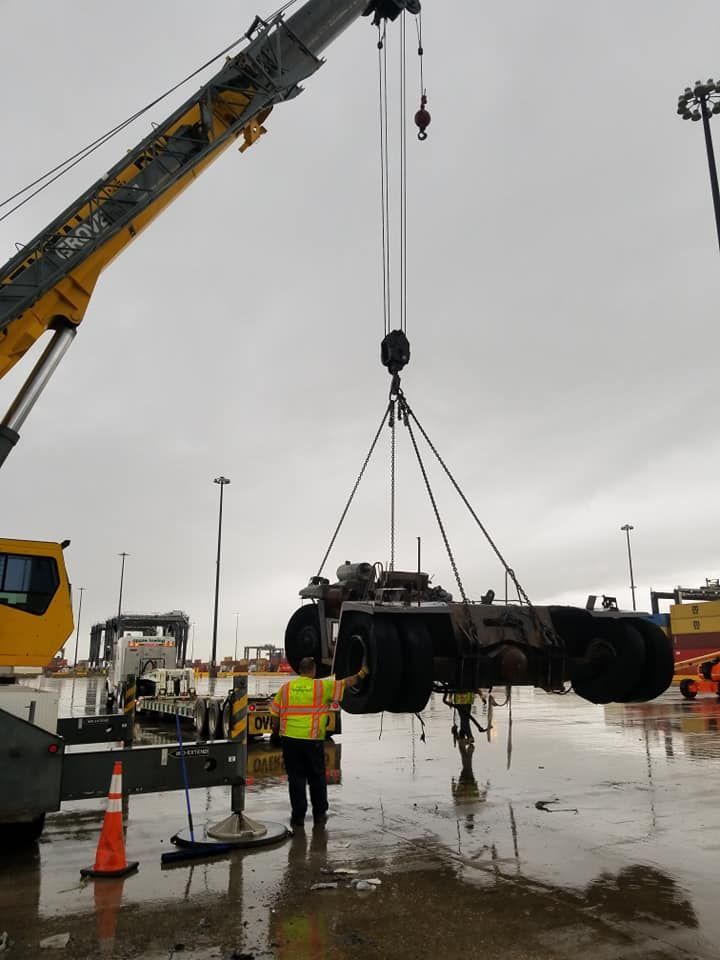 A crane is lifting a truck in the rain