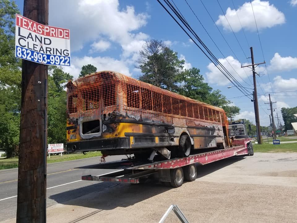 An old school bus is being towed by a tow truck