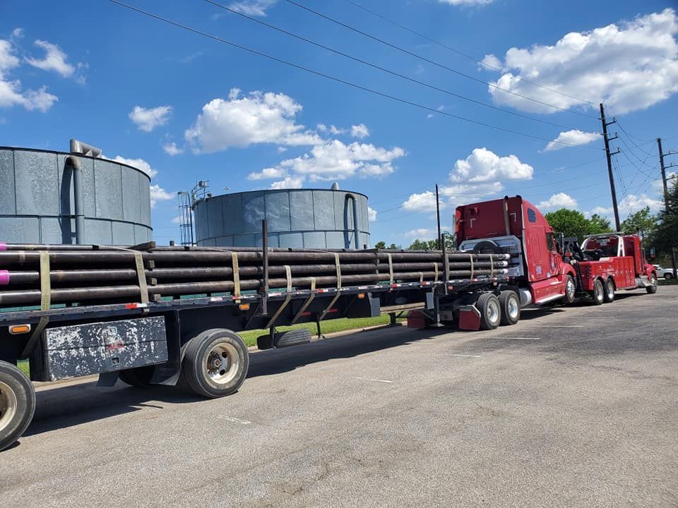 A white truck is parked next to a red truck