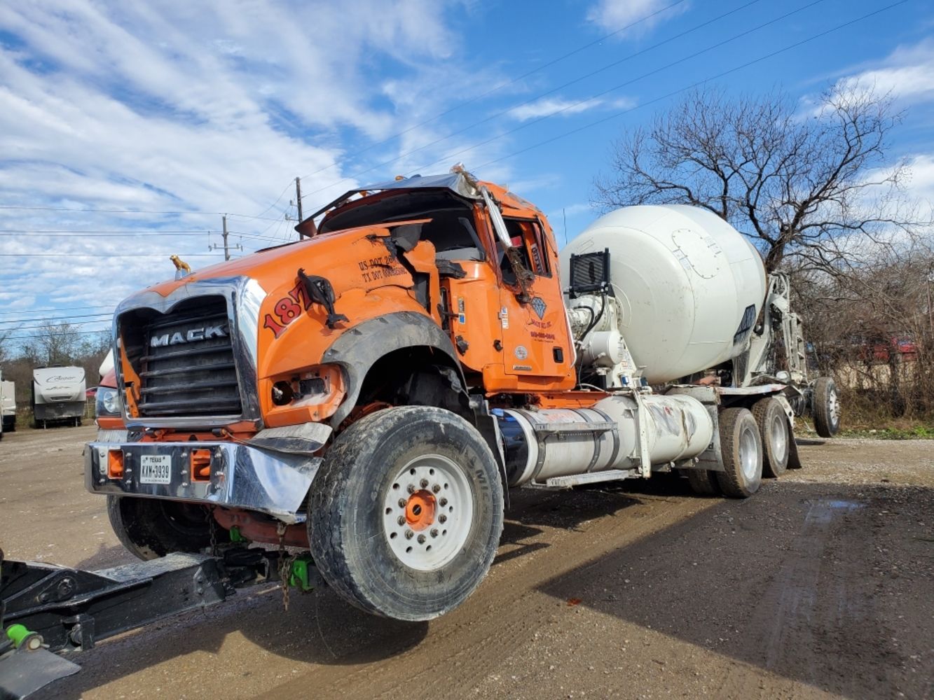 A concrete mixer truck is parked on the side of the road.
