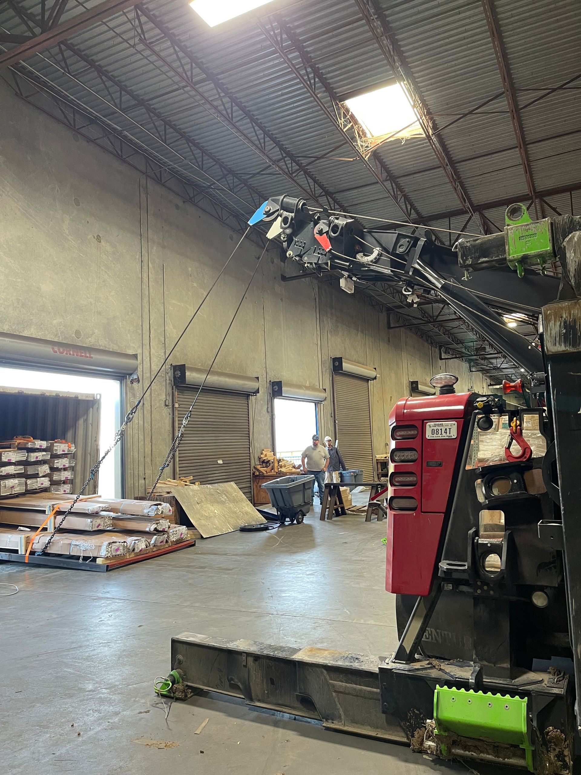 A large warehouse with a forklift in the middle of it.