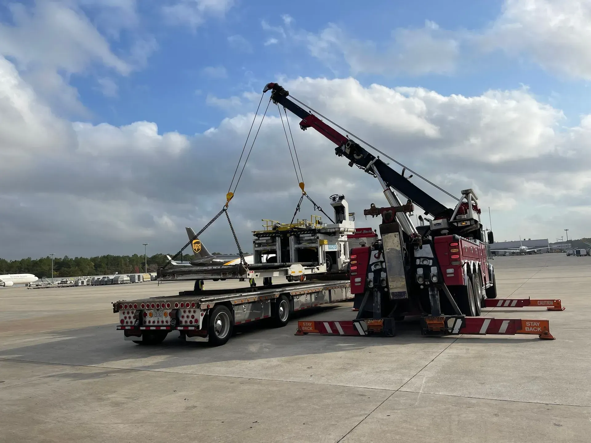 A tow truck with a crane attached to it