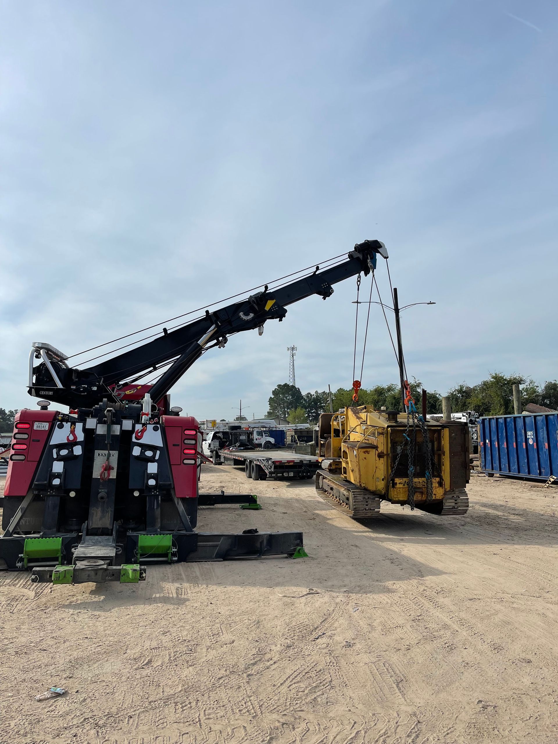 A tow truck with a crane attached to it