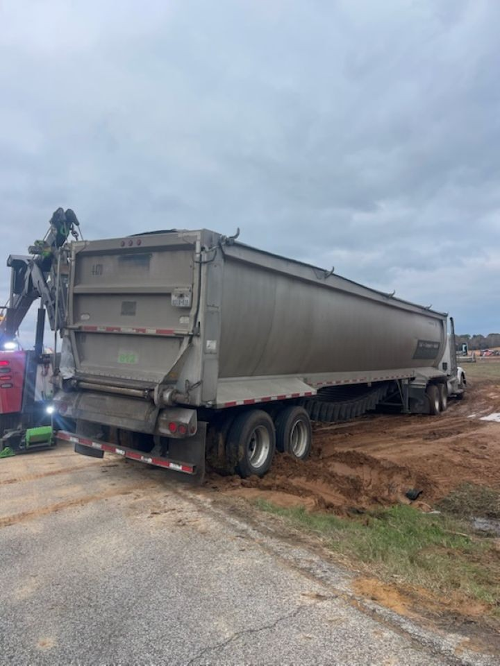 A dump truck is parked on the side of the road.