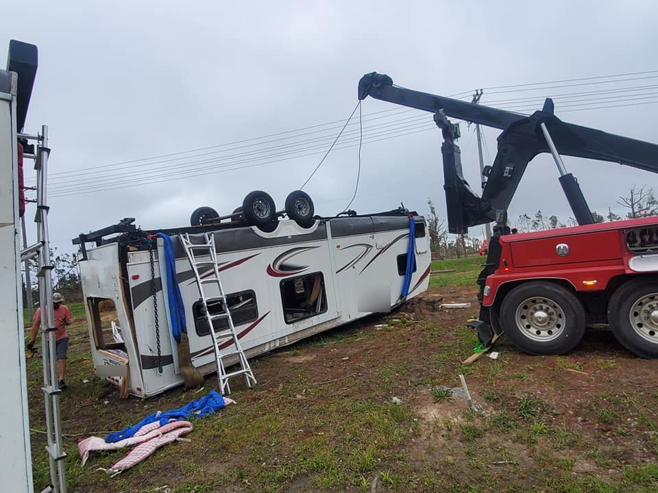 A rv is being towed by a tow truck.