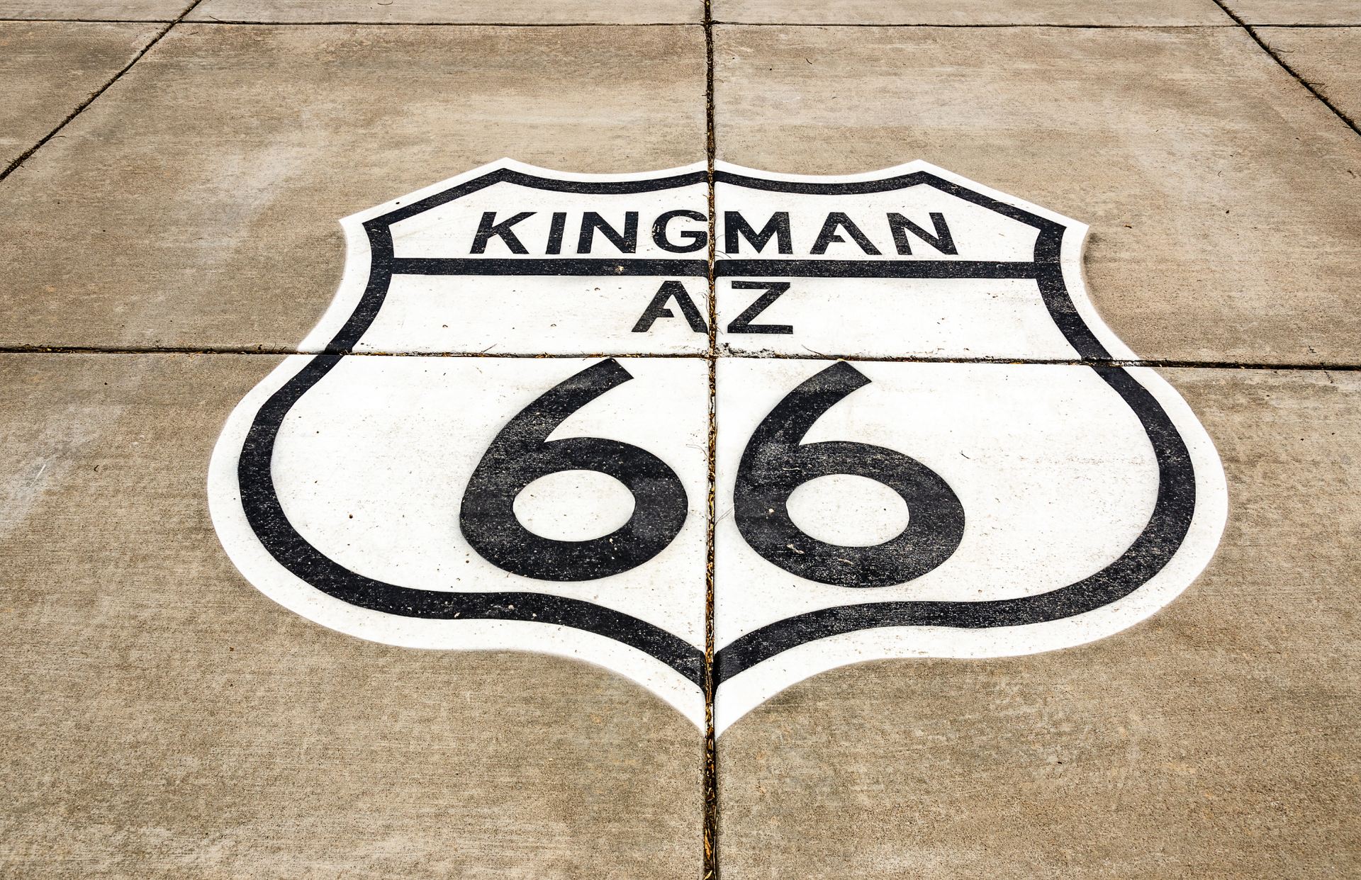 Route 66 sign painted on pavement, stating 