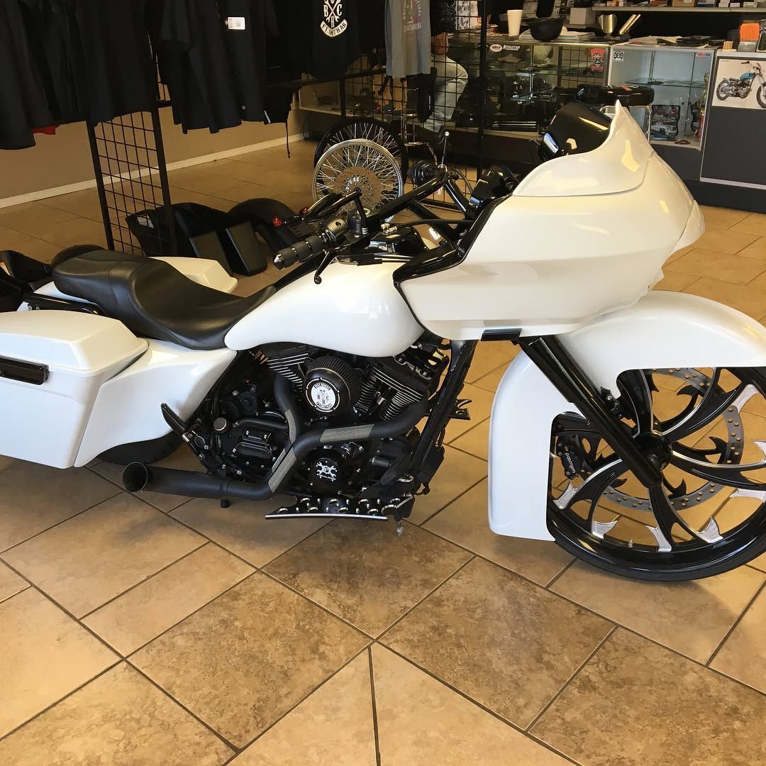 White custom motorcycle with black accents in a showroom.