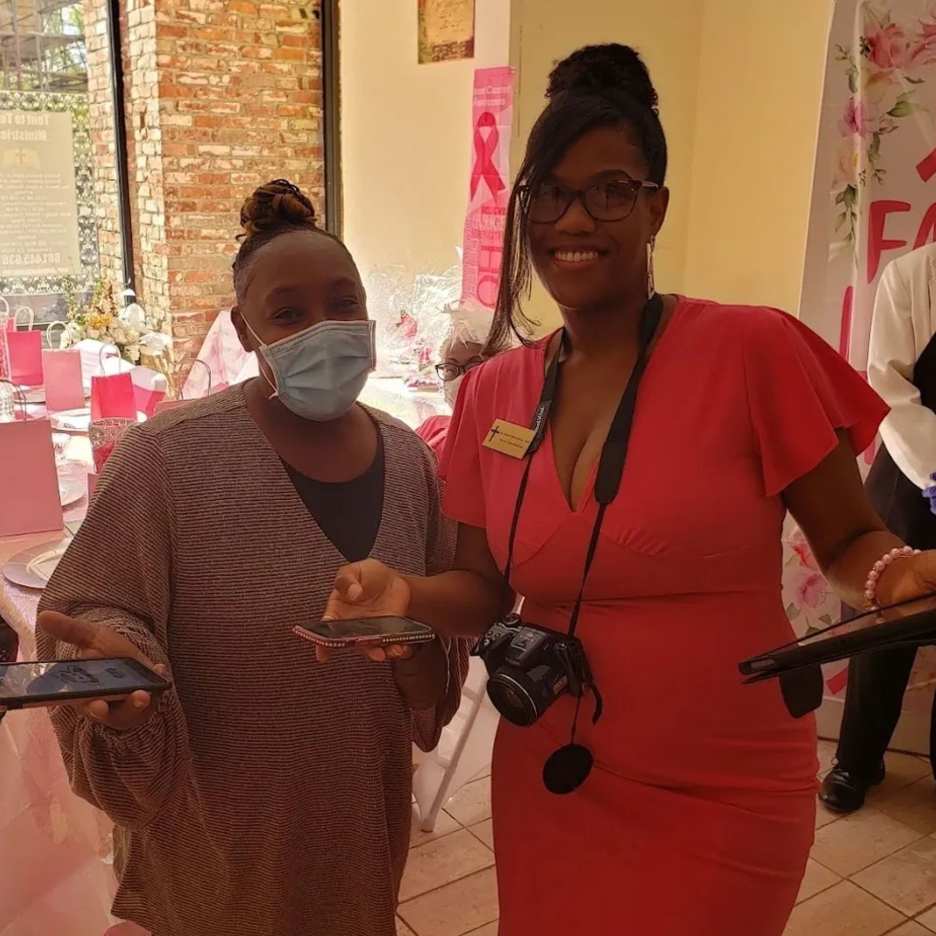 Two women wearing face masks are standing next to each other